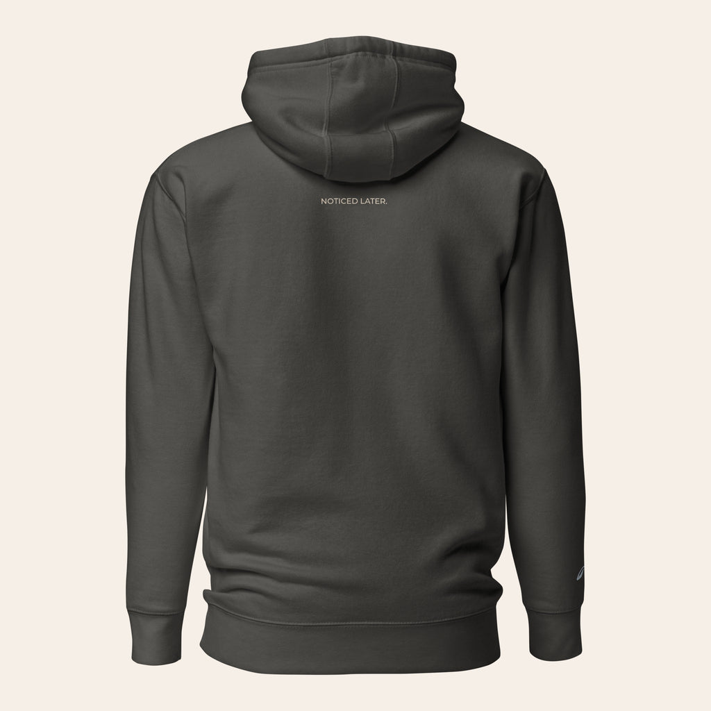 LOUPI GANG Noticed Later Hoodie in Vintage Black, back view, NOTICED LATER. printed in sand just below the hood.