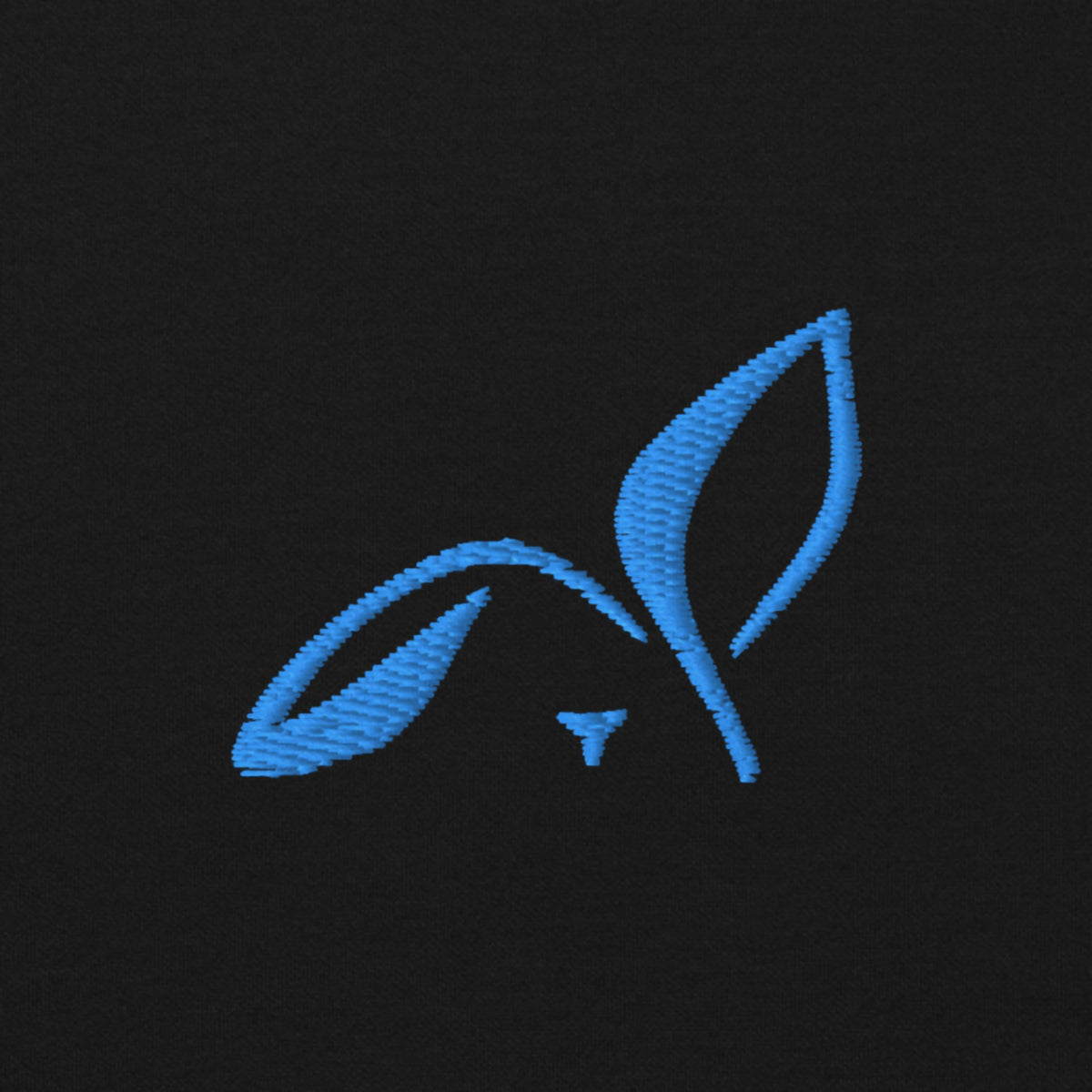 Close-up of the light blue embroidered LOUPI GANG rabbit on the left chest of the black Side Note Hoodie.