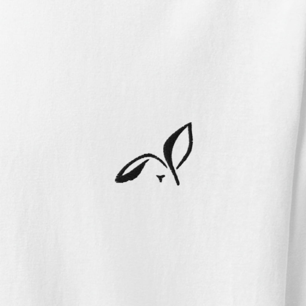 Close-up of the black embroidered LOUPI GANG rabbit on the left chest of the White Signature Embroidered Tee.