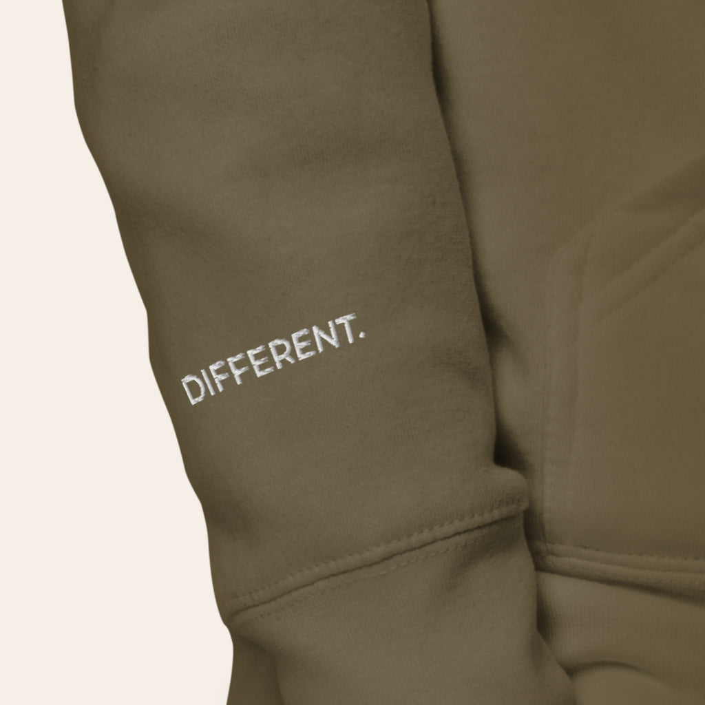 Close-up of the right cuff of the Second Look Hoodie, embroidered DIFFERENT. in white thread.