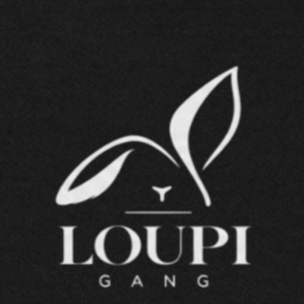 Close-up of the white LOUPI GANG rabbit and wordmark printed on the black fleece just under the hood of the Side Note Hoodie.