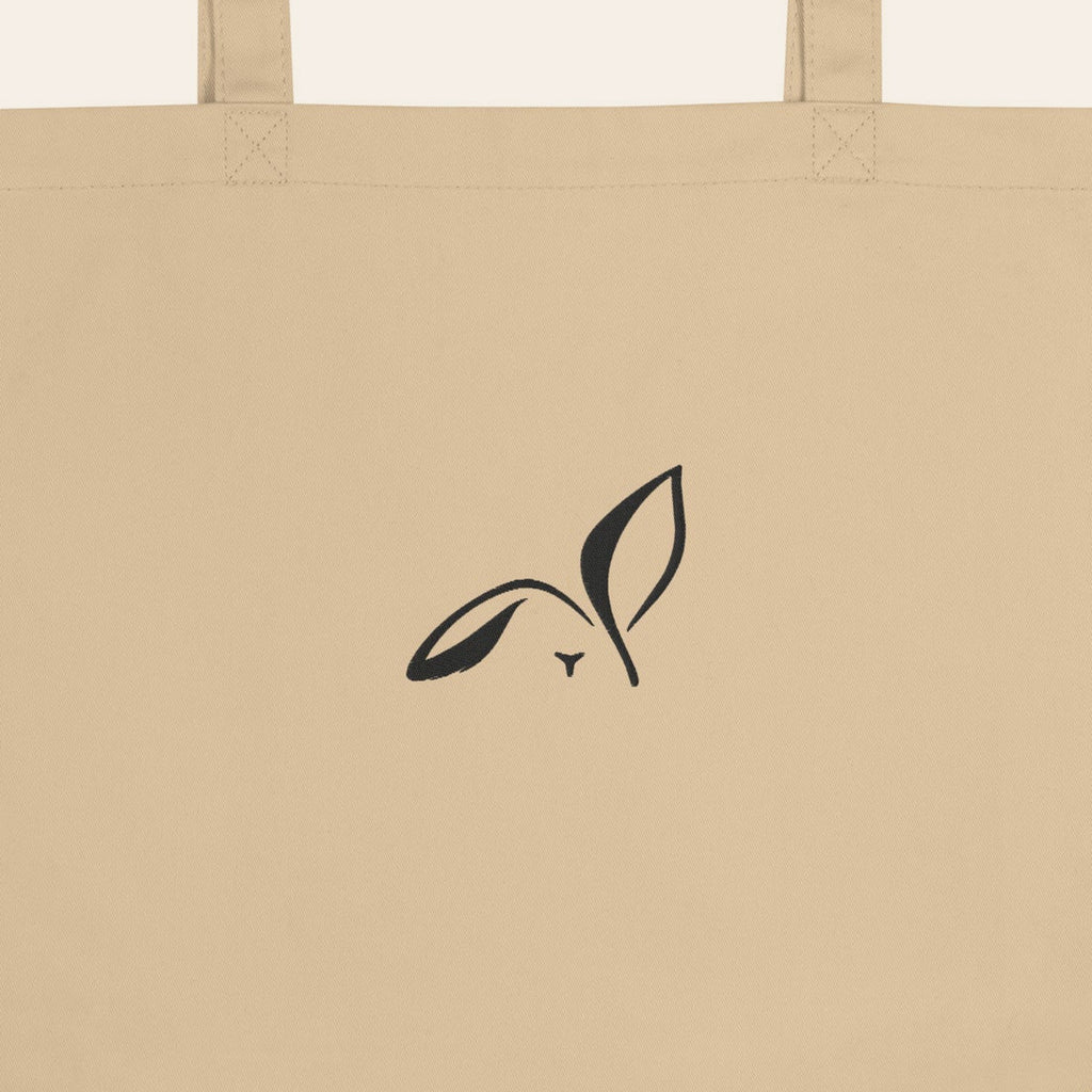 LOUPI GANG Everyday Organic Tote in Oyster, close-up of the black embroidered rabbit and handle stitching