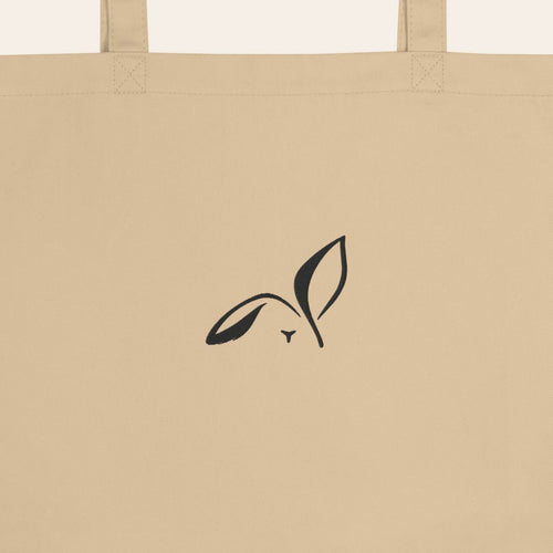 LOUPI GANG Everyday Organic Tote in Oyster, close-up of the black embroidered rabbit and handle stitching