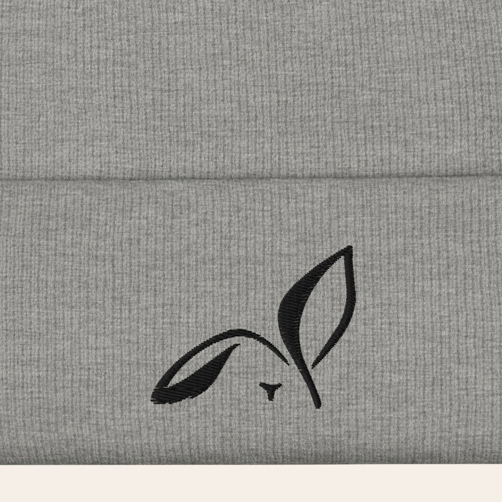 LOUPI GANG Icon Beanie in Heather Grey, close-up of the black embroidered rabbit on the ribbed cuff