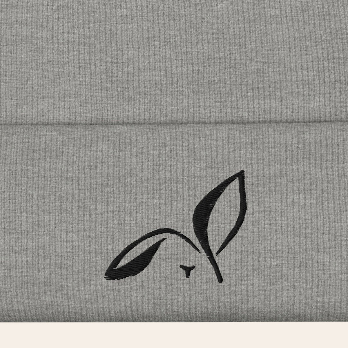 LOUPI GANG Icon Beanie in Heather Grey, close-up of the black embroidered rabbit on the ribbed cuff